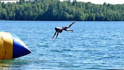 Beautiful northern Minnesota lake with people enjoying active recreation on sunny day