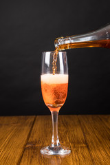 red champagne glass on a wooden background