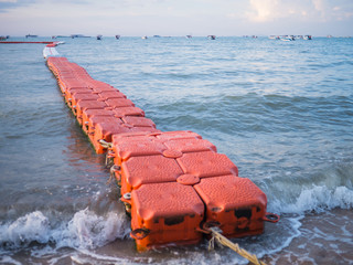 Fototapeta premium Floating wave breaker and rope on beach