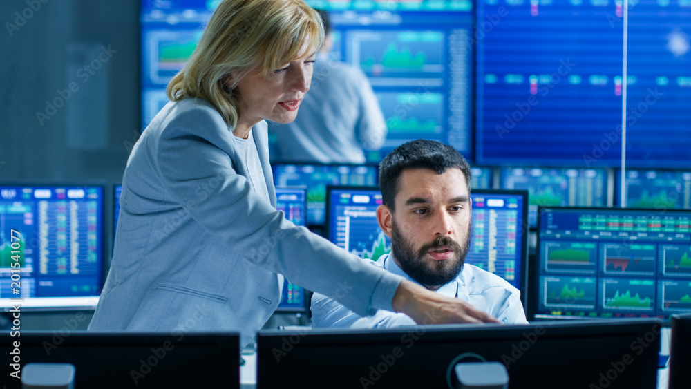 Poster in the stock market firm head of the department helps professional trader. they're surrounded by scr