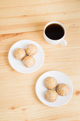 gingerbread on plates and black coffee on a wooden background. breakfast or snack