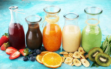 Selection of colorful smoothies on rustic background