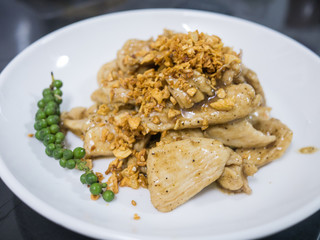 Stir chicken with garlic and pepper on white dish