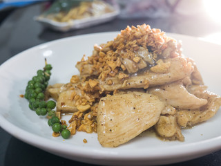 Stir chicken with garlic and pepper on white dish