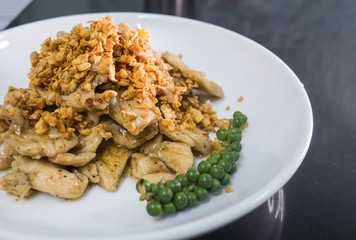 Stir chicken with garlic and pepper on white dish