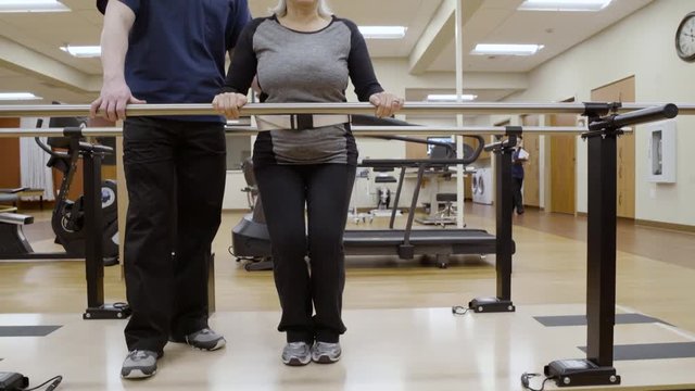 Medium shot of a senior woman doing squats