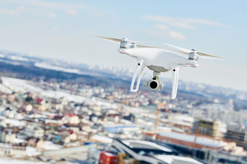 Fototapeta na wymiar drone quadcopter with digital camera hovering over city