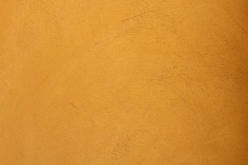 Yellow plaster on a concrete wall. Background. Texture.