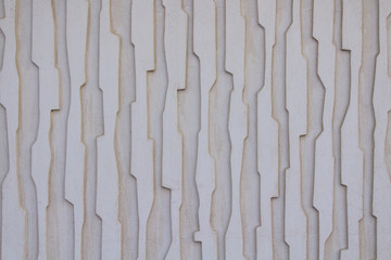 Fototapeta premium The concrete wall of the house with vertical stripes. Background. Texture.