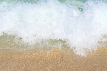 Beautiful small waves on the sea and sandy shell shore. Background.