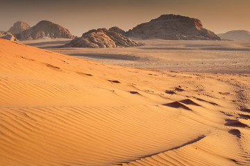 Fototapeta na wymiar hot dusk in sand dunes in desert Wadi rum in Jordan