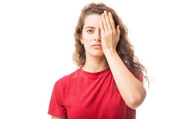Fototapeta premium Young woman covering one eye