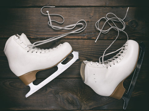old white female skates for figure skating with unbound laces