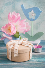 Pink tulip flowers, lit candle