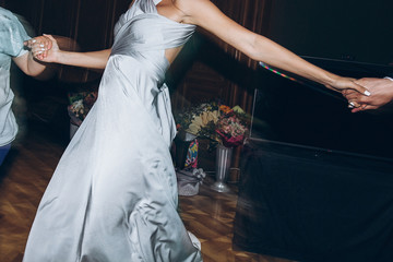 happy stylish people dancing and having fun at wedding reception in restaurant. guests dancing in light, people in motion at party in club. fun moments.. © sonyachny