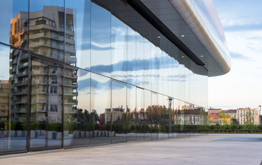 Milan cityscape: new modern buildings reflected in a large shop window in a residential and business district.
