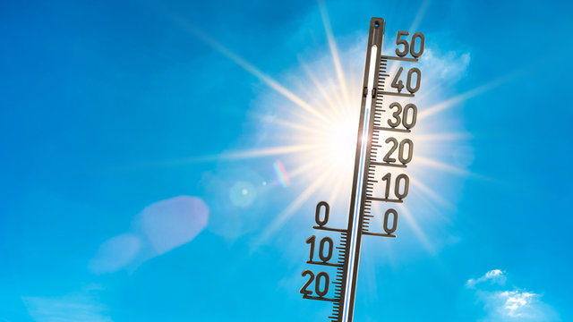 Summer background, bright sun with thermometer