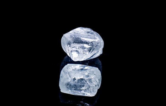 Raw diamond isolated on black background.