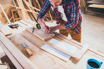 Carpenter Measuring A Wooden Plank