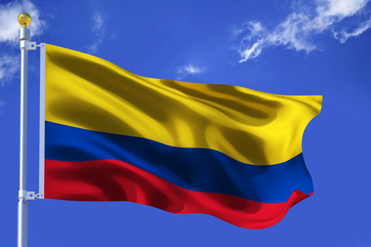 Silk Waving flag with flagpole of Colombia on background of blue sky with clouds .3d illustration.
