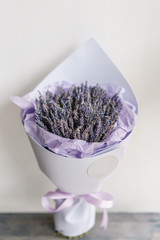 beautiful bouquet lavender on table . dried flowers lilac color. placed in a paper bag
