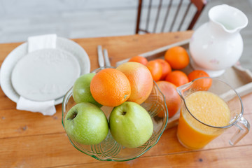Still life: oranges and glass of juice on a wooden table. vitamins and healthy lifestyle concept