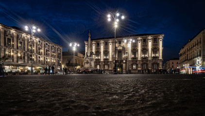 Catania by night. Lifestyle at the elephant fountain in Dome square. Sicily, Italy.