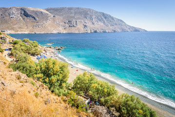 Beautiful sunny coast view to the greek blue sea with crystal clear water beach with some boats...