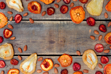 Dried Fruit and Nut Border Frame in Autumn Colors with Wood Background