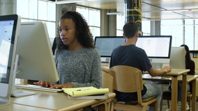 Female student studying with a computer