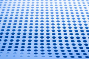 Abstract light blue colored surface with holes built in a row for creativity, wallpapers and backgrounds.