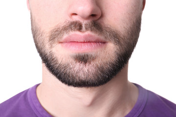 Obraz premium Young man on white background, closeup. Focus on lips