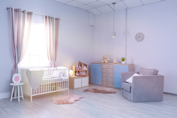 Baby room interior with comfortable crib and armchair