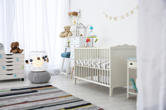 Cozy baby room interior with crib