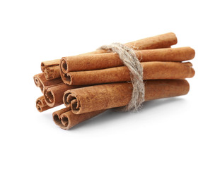 Tied cinnamon sticks on white background