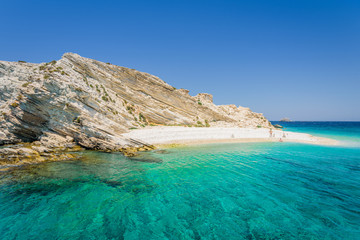 Beautiful sunny coast view to a small greek island and crystal clear blue water beach with some...