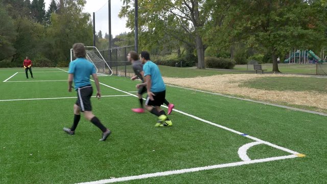 Male soccer players playing soccer game.