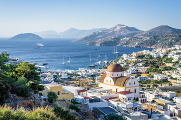 Beautiful mediterranean greek village Pantelis sourrounded by a mountain with ancient castle located at the aegean sea with colorful houses and lovely churches basilicas, Leros, Dodecanese, Greece
