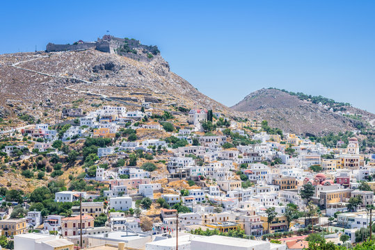 Beautiful mediterranean greek village Pantelis sourrounded by a mountain with ancient castle located at the aegean sea with colorful houses and lovely churches basilicas, Leros, Dodecanese, Greece