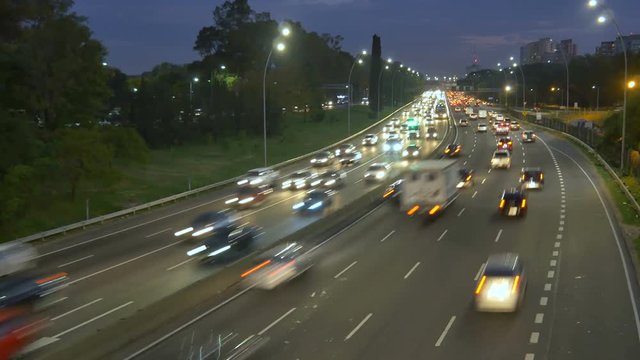Time lapse over highway traffic &ndash; jam. Dusk, Magic Hour, night.