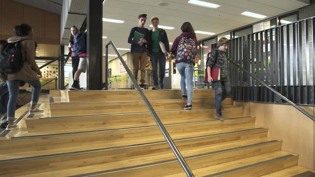 Wide shot of students passing-by on the stairs