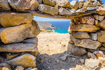 Beautiful sunny coast view to the greek beach Psili Ammos and blue aegean sea with crystal clear water sandy beach with some boats fishing cruising small hills covering, Patmos, Dodecanese, Greece 
