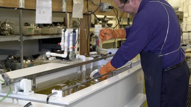 Silversmith working on a teapot