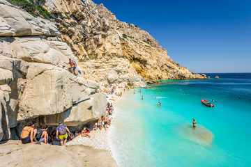 Fototapeta na wymiar Beautiful sunny bay view to amazing paradise holiday place with crystal clear blue water sandy beach for sunbathing swimming relaxing, Ikaria Island, Seychelles Beach, Sporades/ Greece - 08 01 2017