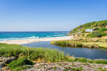 Sunny beautiful summer beach coast view to the greek blue sea white pure sand perfect for holiday relaxing swimming playing , Ikaria Island, Livadhi Beach, Messakti Beach, Armenistis , Sporades,Greece