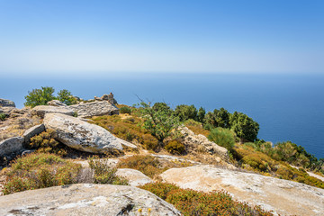 Beautiful holy greek old stone church chapel of Agios Alexandros near Kouniadi situated high above the mediterranean sea on a mountain near old forsaken village Vrakades, Ikaria Island, Greece