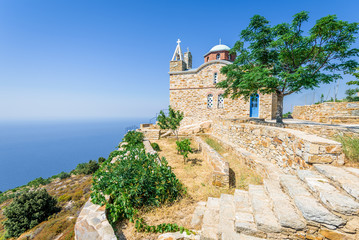 Beautiful holy greek old stone church chapel of Agios Alexandros near Kouniadi situated high above the mediterranean sea on a mountain near old forsaken village Vrakades, Ikaria Island, Greece