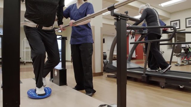 Medium shot of a senior man doing stability exercise