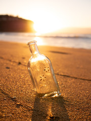 A bottle buried in the sand