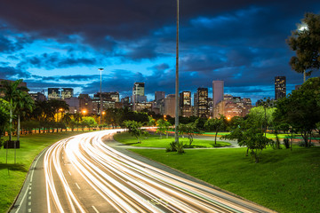 Four Lane Highway Crossing Flamengo Park at Night With Light Trails From Vehicles, and Rio de...
